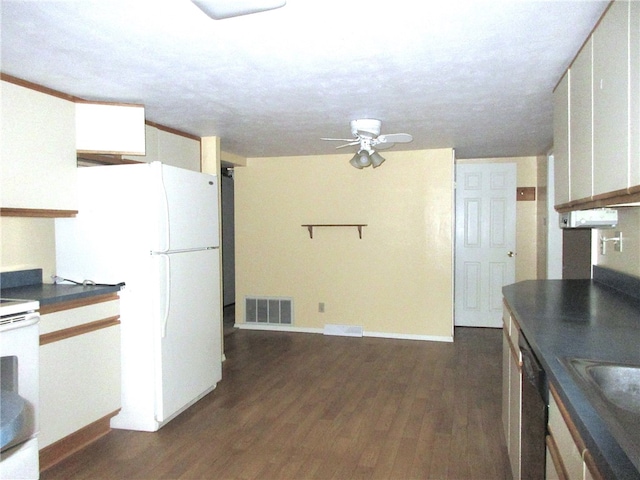 kitchen with white cabinetry, dark hardwood / wood-style flooring, sink, white appliances, and ceiling fan