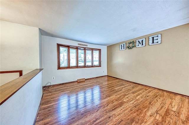 spare room with hardwood / wood-style floors