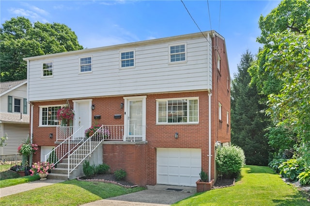 view of front of property with a front yard and a garage