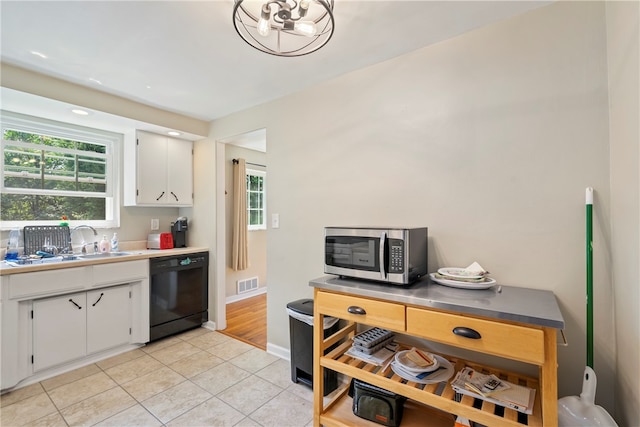 kitchen featuring light wood-type flooring, sink, dishwasher, and white cabinetry