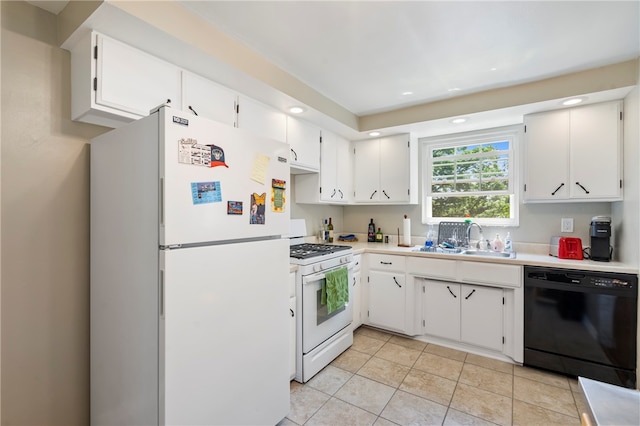 kitchen with sink, white cabinetry, white appliances, and light tile patterned floors