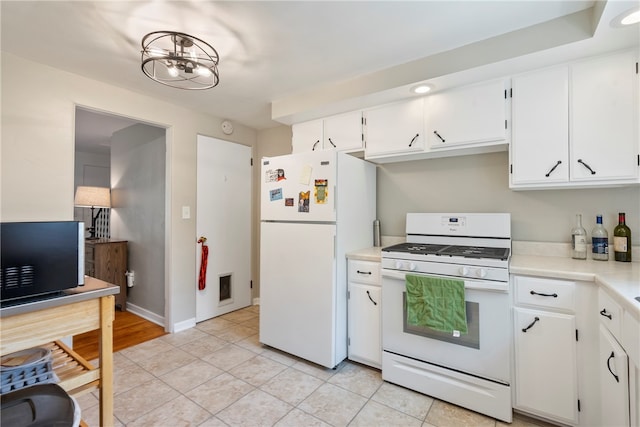 kitchen featuring white appliances, light hardwood / wood-style floors, and white cabinetry