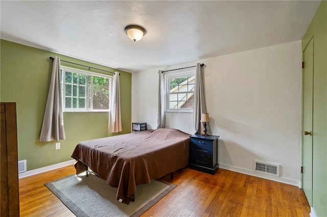 bedroom with wood-type flooring