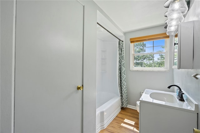 bathroom featuring vanity, hardwood / wood-style floors, and shower / bath combo