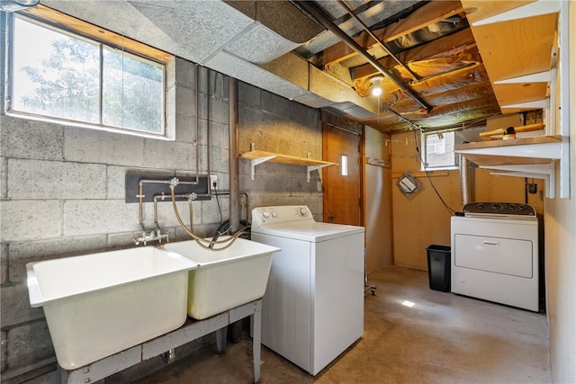 laundry area with washer and clothes dryer and a healthy amount of sunlight