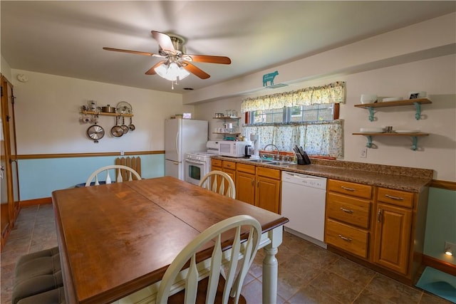 kitchen featuring white appliances, ceiling fan, and sink