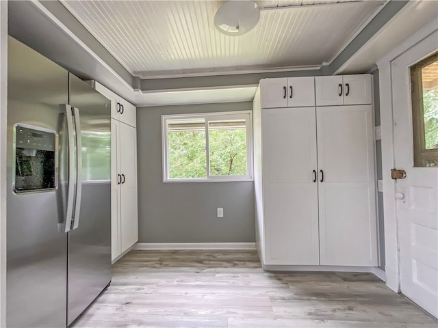 kitchen featuring white cabinets, stainless steel fridge with ice dispenser, and light wood-type flooring