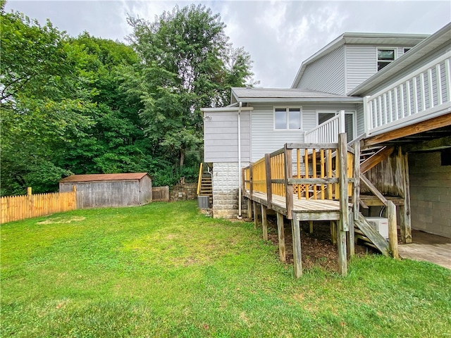 view of yard featuring a storage unit and a wooden deck