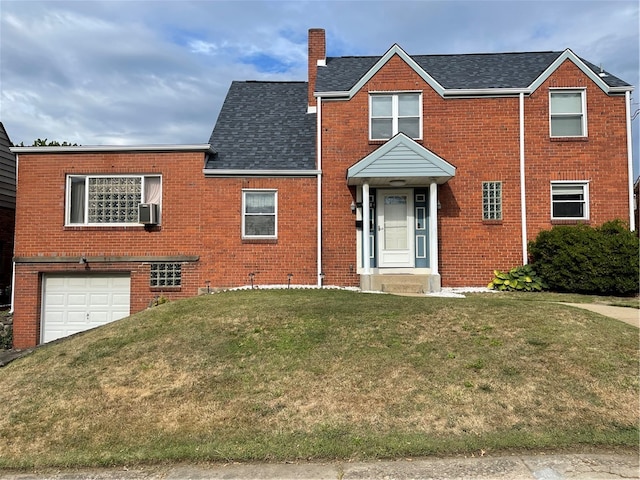 view of front facade featuring a garage, cooling unit, and a front yard