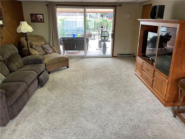 living room with light carpet, wooden walls, and baseboard heating