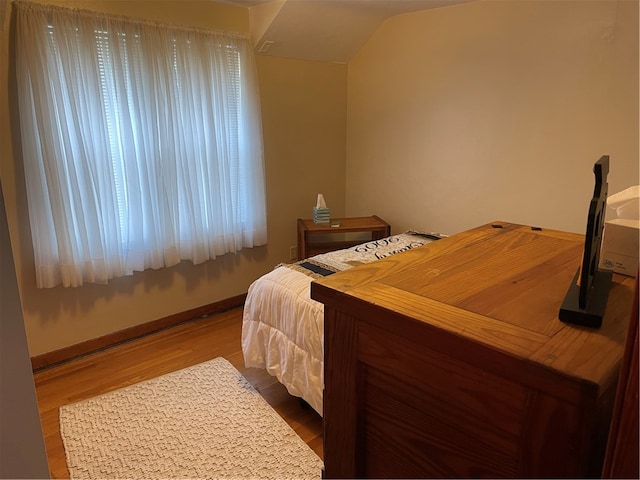 bedroom with hardwood / wood-style flooring