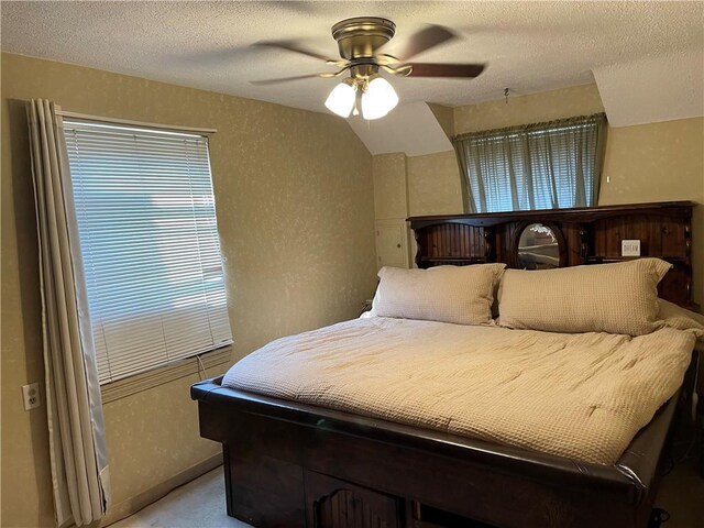 carpeted bedroom with a textured ceiling and ceiling fan