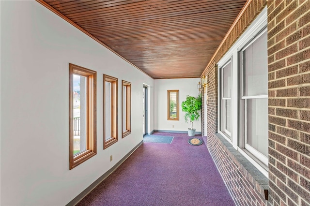 unfurnished sunroom featuring wooden ceiling and a healthy amount of sunlight