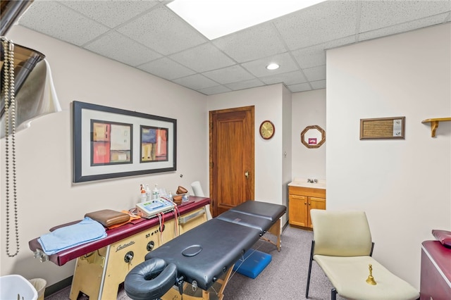 workout room with carpet flooring and a drop ceiling