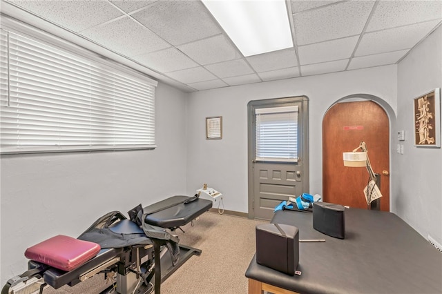 workout room featuring a drop ceiling and carpet floors