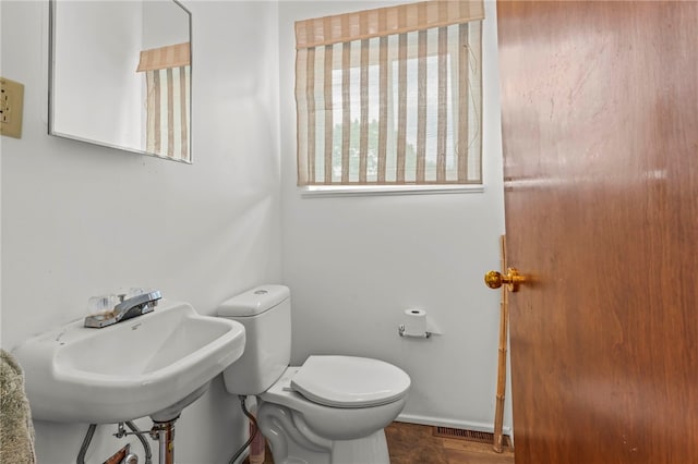 bathroom with sink, toilet, and tile patterned flooring