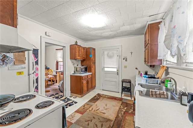 kitchen featuring light tile patterned floors, white refrigerator, stove, sink, and ornamental molding