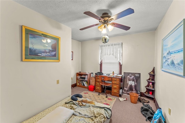 carpeted bedroom with a textured ceiling and ceiling fan