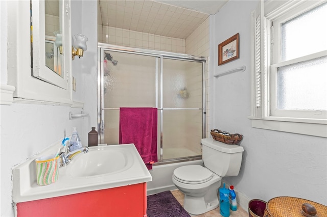 full bathroom with vanity, combined bath / shower with glass door, and toilet