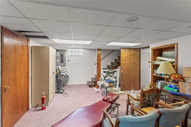 workout room with a drop ceiling and carpet floors