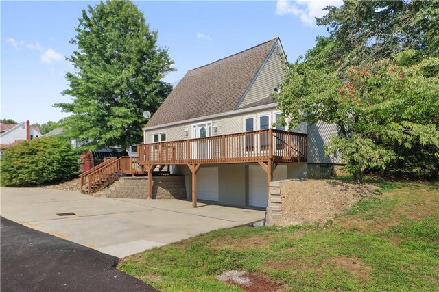 exterior space featuring a garage and a wooden deck