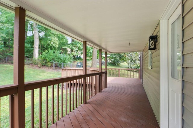 wooden terrace featuring a yard