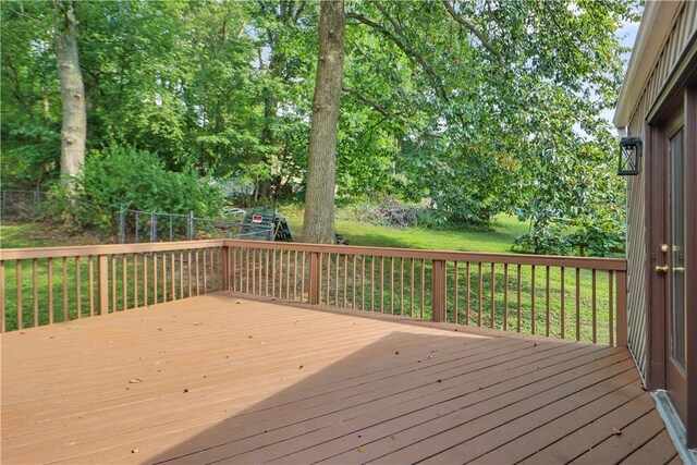 wooden deck featuring a yard