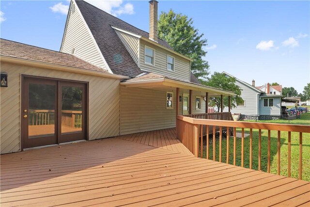 wooden terrace featuring a yard