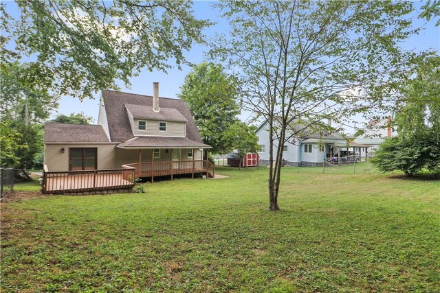 view of yard with a deck and a storage shed