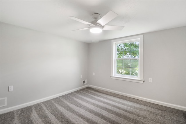 spare room with carpet and ceiling fan