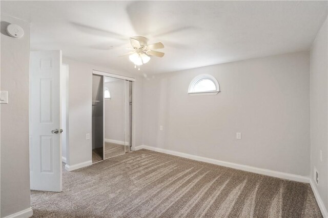 unfurnished bedroom featuring carpet, a closet, and ceiling fan