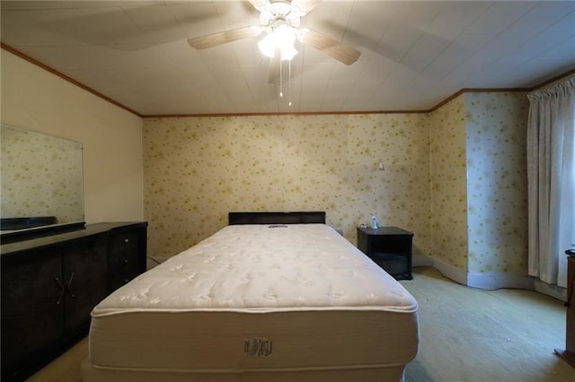 carpeted bedroom with ornamental molding and ceiling fan