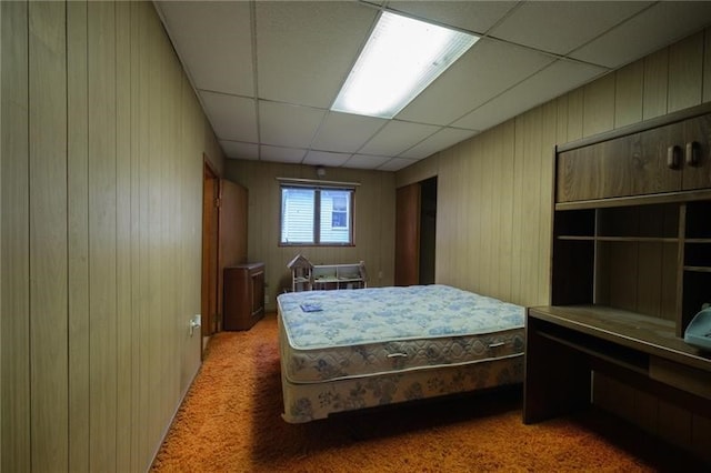 bedroom featuring carpet floors and a paneled ceiling