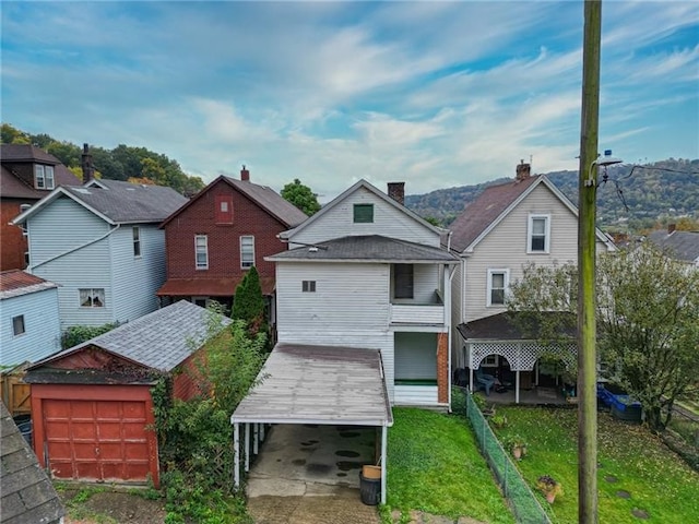 rear view of house featuring a yard