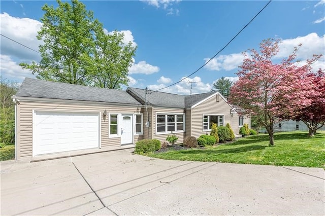 view of front of house with a garage and a front yard