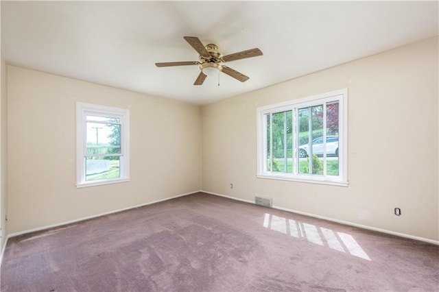 carpeted empty room featuring ceiling fan