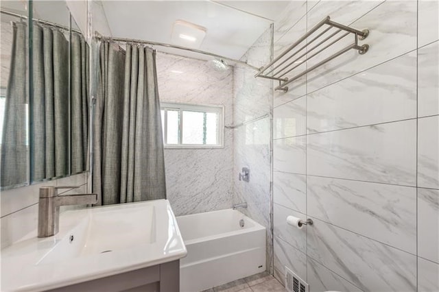 bathroom with vanity, shower / tub combo, tile walls, and tile patterned floors