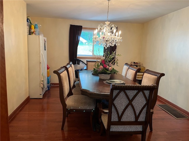 dining space featuring a chandelier and dark hardwood / wood-style flooring