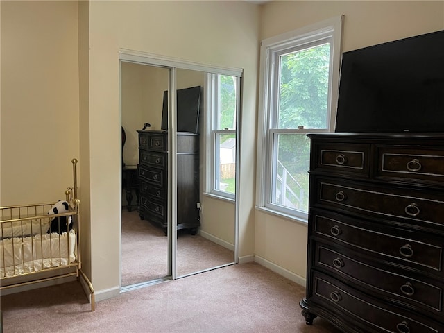 carpeted bedroom featuring a closet