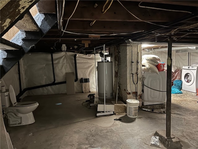 basement featuring washing machine and clothes dryer and water heater