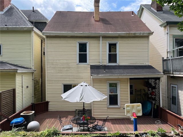 back of house featuring a wooden deck