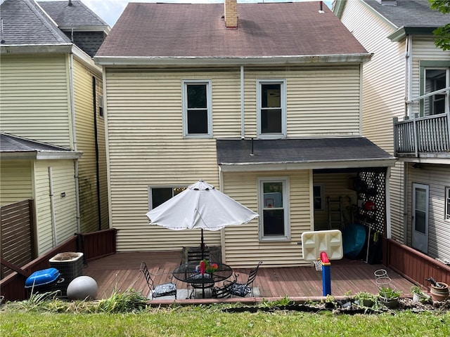 rear view of property featuring central air condition unit and a wooden deck