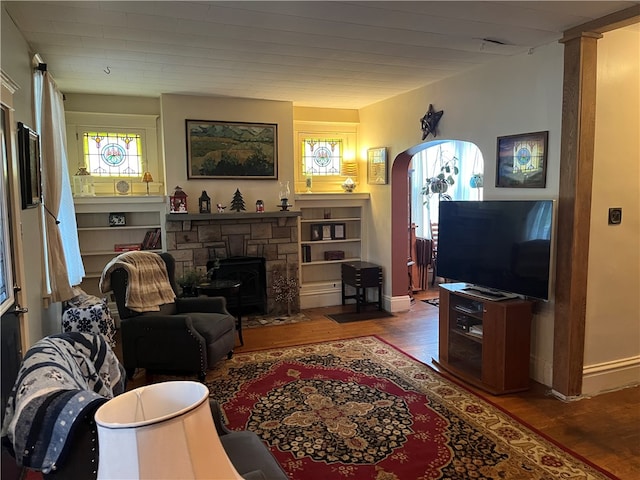 living room with a fireplace and wood-type flooring