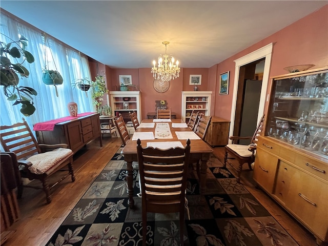 dining room with a chandelier and dark hardwood / wood-style flooring