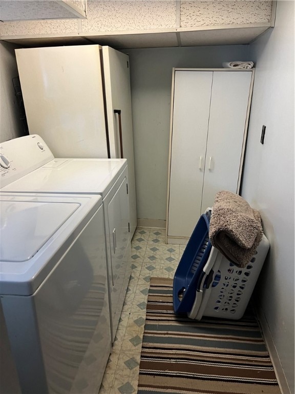 laundry area with tile patterned flooring and separate washer and dryer