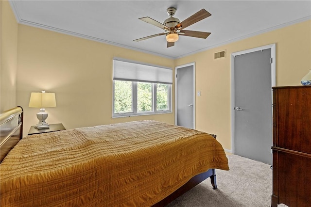 carpeted bedroom with ceiling fan and ornamental molding