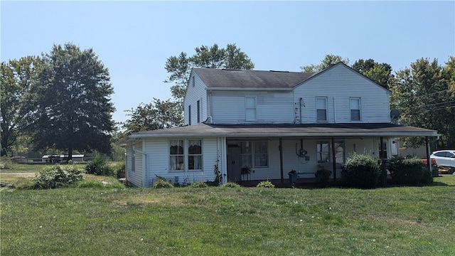 view of front facade featuring a front lawn and covered porch