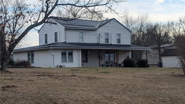 country-style home featuring a front yard and metal roof