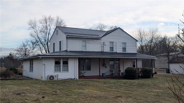 farmhouse inspired home with a standing seam roof, metal roof, covered porch, a front lawn, and ac unit