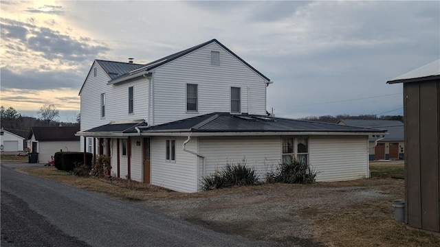 property exterior at dusk with metal roof